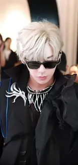 Fashion-forward individual wearing sunglasses with unique accessories.