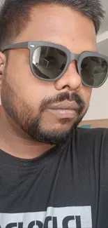 Portrait of a person wearing stylish sunglasses with a modern look.