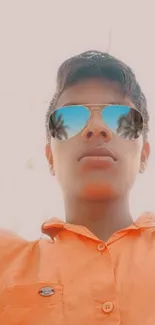 Person wearing sunglasses with orange shirt.