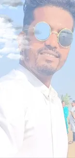 Fashionable man with sunglasses in a dreamy sky background.