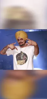 Man with a yellow turban posing energetically in stylish t-shirt.