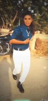 Stylish biker in blue shirt and white pants with vintage motorcycle in urban setting.