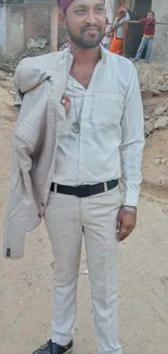 Man in light beige suit with urban background.