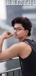 Stylish urban portrait of a man with glasses in a city setting.