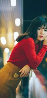 Stylish young woman in urban night setting with vibrant colors.