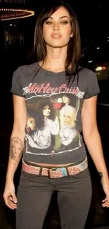 Stylish urban night scene with a graphic tee and tattoos.