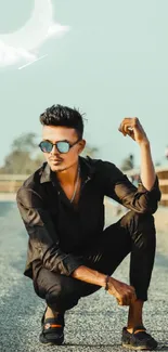 Stylish man posing on a bridge under a crescent moon.