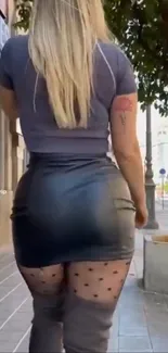 Woman in stylish urban fashion on city street.
