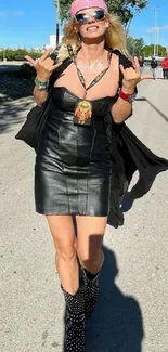 Woman in leather dress walking in urban street under blue sky.