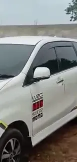 Sleek white car with modern design and black tinted windows.