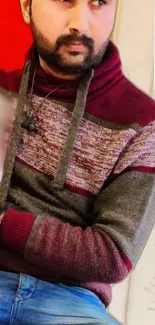 Person wearing a stylish patterned sweater and headphones.