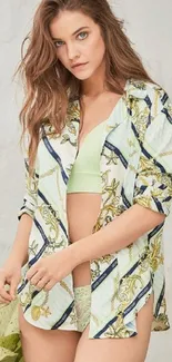 Woman wearing a printed shirt with a pastel green accent for a stylish wallpaper.