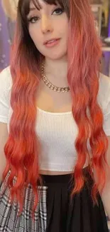 Woman with long, vibrant red hair and stylish attire.