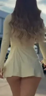 Back view of woman in stylish yellow dress outdoors