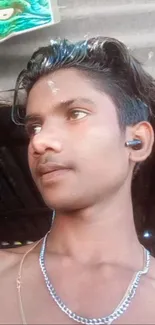 Portrait of a stylish young man with earphones and a casual look.