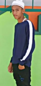 Youth in a casual outfit with a vibrant green background.