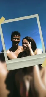 A Polaroid photo of two people against a blue sky, perfect for summer vibes wallpaper.