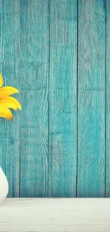 Sunflower in a vase against rustic blue wood background.