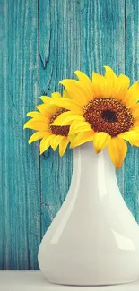 Sunflower arrangement in white vase with turquoise background.