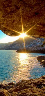 Sunlit cave opening to blue ocean view.