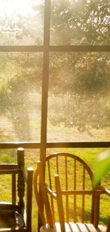 Sunlit view through a rustic window, illuminating wooden chairs and lush greenery.