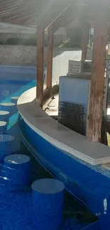 Sunlit poolside bar with blue water tiles.