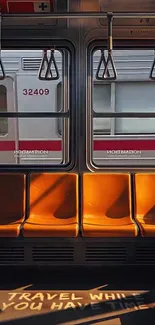 Sunlit orange seats in a subway with urban view.