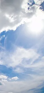 Bright blue sky with sunlight and white clouds in a tranquil view.