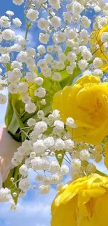 Yellow flowers and white baby's breath against a blue sky.