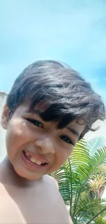 Cheerful child smiling in a sunny outdoor setting.