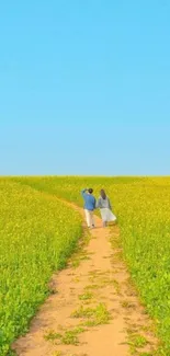 Couple walking along a sunny field path with blue sky.