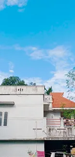 White house with red roof and blue sky background.