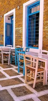 Mediterranean outdoor cafe with blue windows and wooden tables.