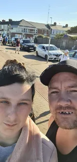 Urban couple strolling under a sunny blue sky.