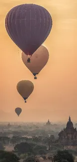 Hot air balloons float over ancient temples at sunrise.