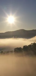 Beautiful sunrise over foggy mountains with sunlight beams.