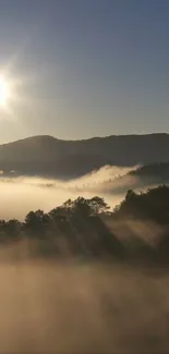 Sunrise over misty mountains with warm golden hues.