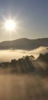 Sunrise over misty mountains with golden light and fog.