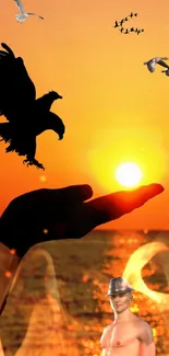 Silhouette of a hand and birds against a vibrant sunset with orange glow.