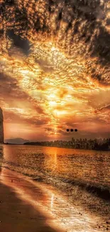 Golden sunset over a tranquil beach with dark cliffs and reflective ocean water.