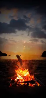 Bonfire on a serene beach during sunset with a darkened sky.