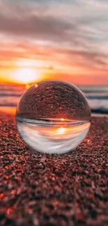 Sunset beach with crystal ball reflection, vibrant orange hues.