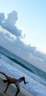 Gymnastics on a beach with sunset and ocean waves.