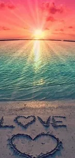 Beautiful sunset over beach with 'LOVE' written in sand.