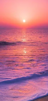 Serene sunset view over a pink-hued ocean at the beach.