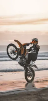 Motorcycle performs a sunset stunt on the beach.