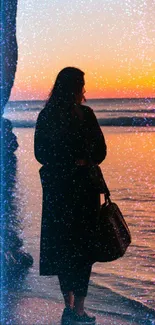 Woman standing by the ocean during a vibrant orange sunset by the beach.