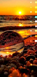 Crystal ball reflecting a stunning sunset over a pebble-covered beach.