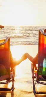 Couple relaxing on chairs at beach during sunset.