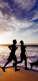 Two runners with a dog at sunset on a scenic beach with waves.